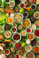 Fresh, fragrant spices and herbs arranged in an array of colors, sitting on a soft green backdrop, bringing flavor and zest to any kitchen