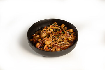 Tasty udon served in a black plate on white background, stock
