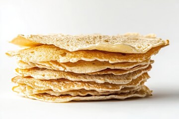 Stack of pancakes isolated on white background with syrup and butter toppings