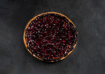 Berry round shortbread tart on dark grey background