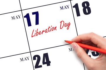 May 17. Hand writing text Liberation Day on calendar date. Save the date.