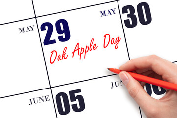 May 29. Hand writing text Oak Apple Day on calendar date. Save the date.