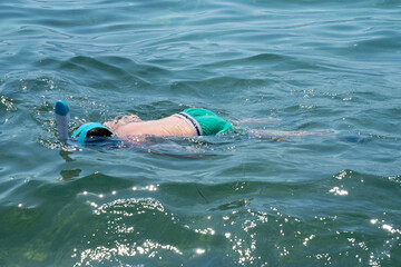 Teenage boy enjoying snorkeling in sea water, enjoying active summer holidays, exploring underwater...