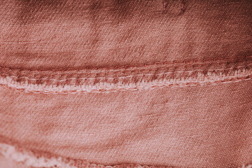 Close-up of pink denim fabric texture, ideal for fashion and textile backgrounds. Pink jeans denim