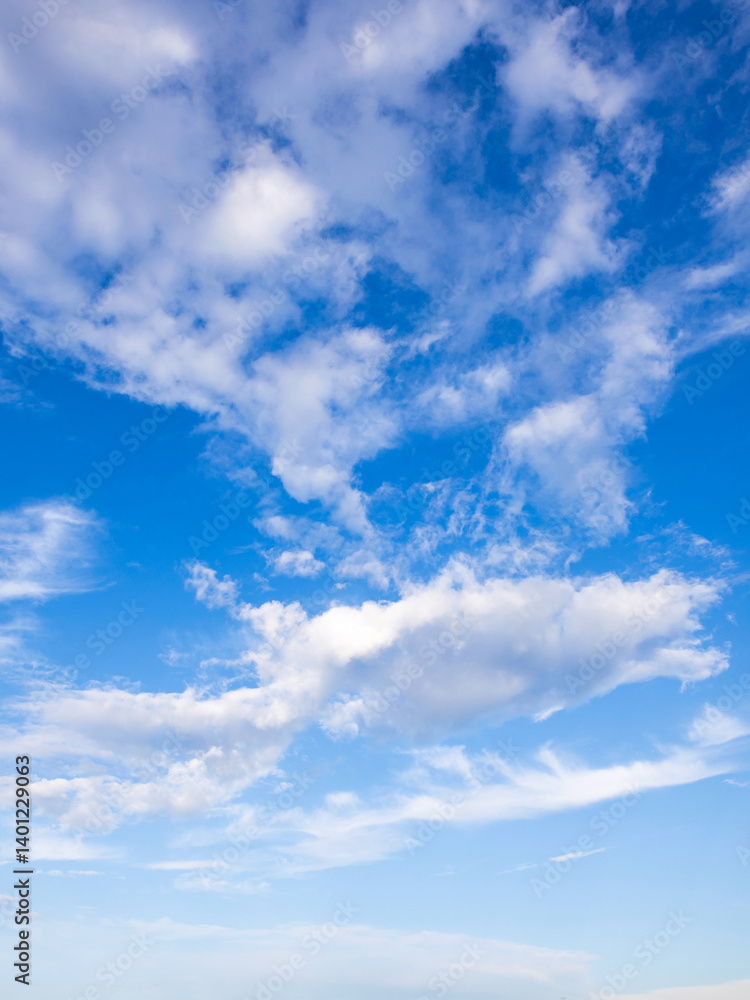 Wall mural the sky is blue and clear with a few clouds scattered throughout