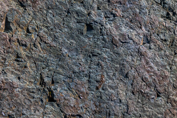 Roughly cleaved metamorphic rock, splintery texture, natural surface, outdoor, daylight