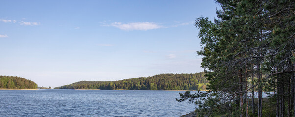 A beautiful lake with a clear blue sky above it