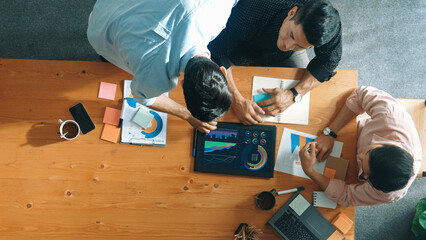 Executive manager explain financial graph to colleague at meeting room. Top aerial view of diverse...