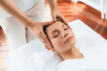 Caucasian woman enjoying relaxing anti-stress head massage and pampering facial beauty skin...