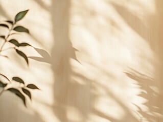 Sunlight shadows of leaves on beige wall