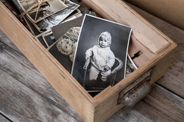 old family photographs, pictures from 1935 in sepia color on wooden table, home archive documents,...