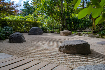 Zen garden with sand patterns, smooth stones, and a serene background