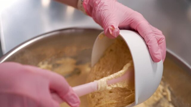 Pastry chef mixes dough, baking sponge cake. Confectioner woman working kitchen