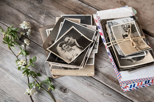 old family photographs, pictures from 1935 in sepia color on wooden table, home archive documents, concept of family tree, genealogy, memories, memory of ancestors, family tree, nostalgia