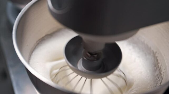 Whipping egg whites for meringue by planetary mixer. Texture for crispy dessert