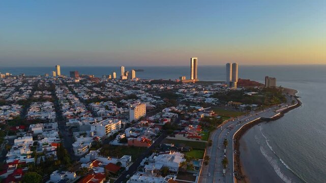Aerial video flying over Veracruz, Mexico in the municipality of Boca del Rio at sunrise. The city looks huge and imposing