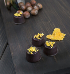 Handmade chocolate candies with filling on dark background