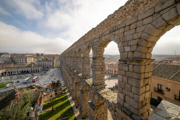 Segovia Aqueduct: A Panoramic View with Tourists at its Base