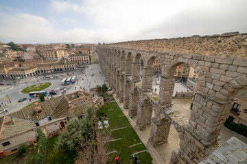 Panoramic View of the Segovia Aqueduct with Tourists Enjoying the Historic Site