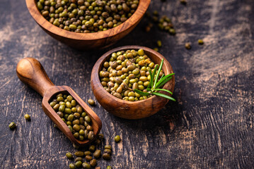 Raw uncooked mung beans on black background