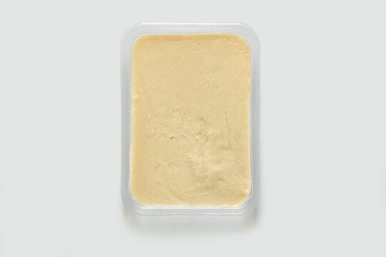 Close-up studio shot of an open plastic pack full of macco of beans. Pack-shot of transparent plastic box, top view shot, white background