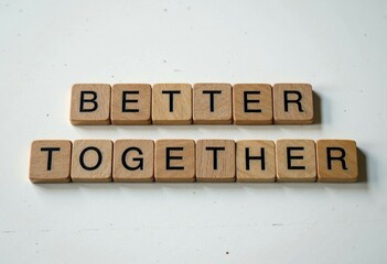 Scrabble tiles forming the phrase better together on light background