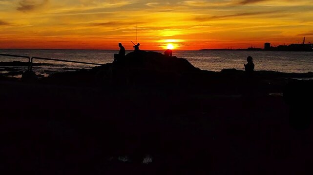 Wide shot video, sunset landscape scene at coast of rio de la plata river, at paseo de los pescadores, parque rodo neighborhood, montevideo city, uruguay
