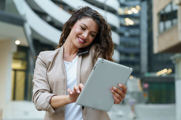 Confident Businesswoman Smiling and Multitasking with Tablet in Modern Urban City Setting