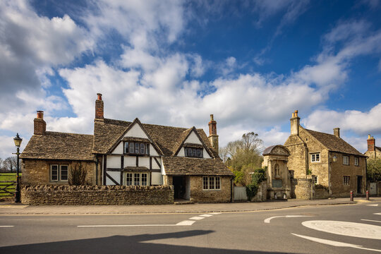Traditional medieval house and WW1 memorial in the historic village of Lacock, Wiltshire, England, Uk