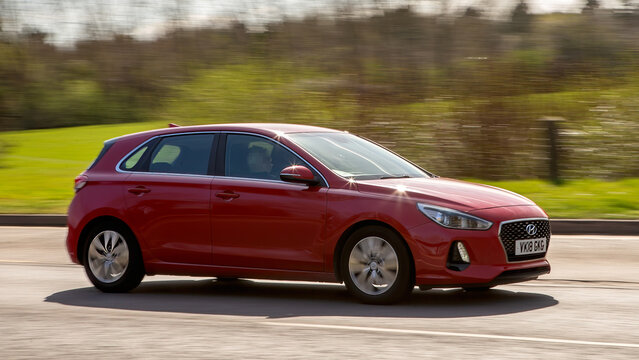 Milton Keynes,UK - Mar 29th 2025:  2018 red Hyundai i30 car driving on a British road.