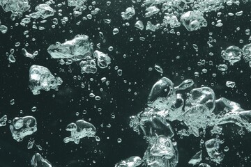 Many water bubbles on dark background, closeup