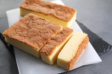 Tasty Japanese Castella sponge cake on grey table, closeup