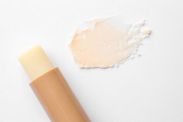 Stick of lip balm and sample on white background, top view