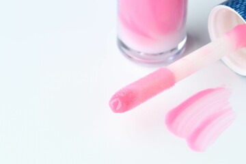 Moisturizing lip balm and applicator on white background, closeup. Space for text