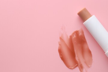 Moisturizing lip balm and lipstick on pink background, top view. Space for text
