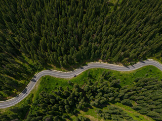 Curve asphalt road on mountain forest summer. Aerial view of the road passing through the mountain and green forest.