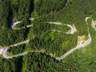 Curve asphalt road on mountain forest summer. Aerial view of the road passing through the mountain and green forest.