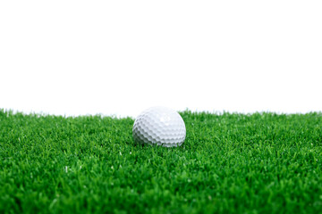 Golf ball on green grass against white background