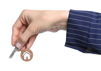 Real estate agent holding key with house shaped keychain on white background, closeup