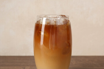 Tasty iced coffee on wooden table, closeup