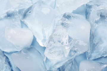 Obraz premium Pieces of crushed ice on light blue background