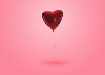 Shiny red heart shaped balloon on pink background