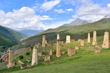 Beautiful view of watchtowers on green slopes in Ingushetia. Erzi tower complex on a clear sunny day.