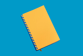 Blank Yellow Notebook on Blue Background – No Logo or Label