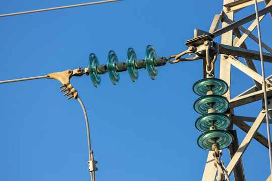 High voltage power line tower with ceramic insulators against clear blue sky. Industrial electricity transmission structure. , Mediterranean, Turkey