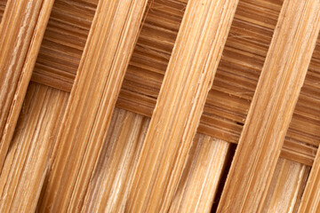 Interlaced bamboo slats creating geometric pattern, revealing natural texture variations through detailed macrophotography close-up