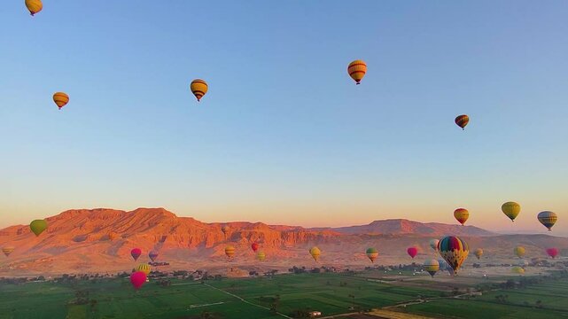 Hot air balloon flying above The Mortuary Temple of Ramesses III at Medinet Habu in Theban Necropolis at Valley of the Kings, Luxor, Egypt