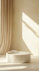 Warm Sunlight Filters Through Soft Curtains Onto a Minimalist Design Space With a Round Stone Surface and Draped Fabric in a Neutral Palette