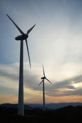 Wind turbines generating renewable energy at sunset, sustainable energy, green technology, eco-friendly environment, energy production, environmental blog, energy magazine