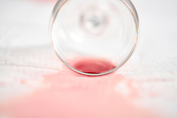 Spilled wine glass on white tablecloth